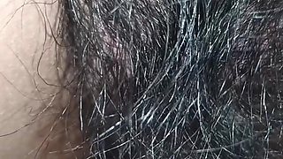 Close up view on a hairy and creamy pussy