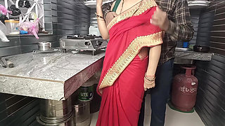 In the kitchen, the brother-in-law made the beautiful sister-in-law in red saree do the doggy style and fucked her.