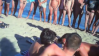 couple fucks at the beach, soon there's a crowd watching and fucking