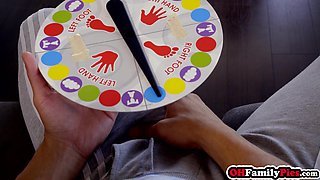 Stepsister playing twister game on cock