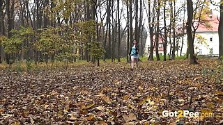 Dark haired pregnant slut sat on stub in woods and pissed