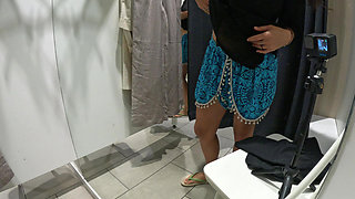 Girl undresses and touches herself in public in the dressing room of a clothing store.