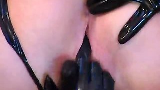 Superb lesbian slave in latex Petova gets pussy licked by a