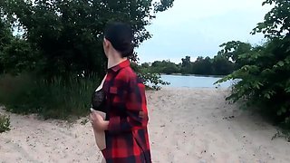 Brunette amateur with small tits shows pussy on public beach