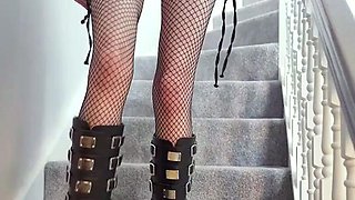 Sexy goth teen posing seductively in fishnet pantyhose