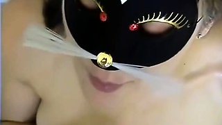 Masked brunette with lovely tits feeds her lust for hot piss