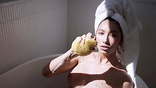 Big tits petite Latina strips in bathtub