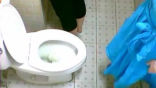 Two cute Asian girls spotted on a toilet cam pissing
