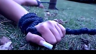 Outdoor prelude of a bondage treatment for a brunette slave
