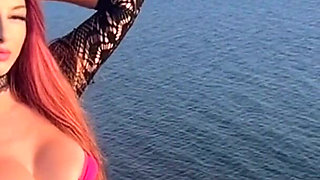 Artemisia Love Wearing a Sexy Bikini and Showing Her Perfect Body by the Ocean While She Smoke
