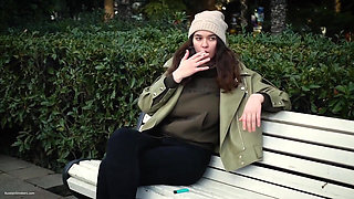 Young Brunette Is Taking an Unhurried Stroll with Allwhite 120mm Cigarette