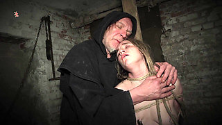 Clamps at the Body of a Tied up Moaning Witch