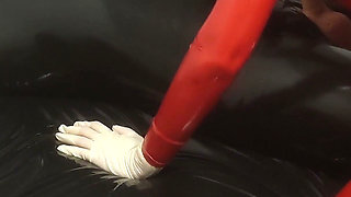 Hot MILF in a Red Latex Catsuit She Is Enjoying It with a Locked Slave. Second Angle