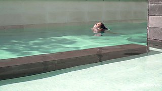 Alluring brunette explores passionate lesbian poolside play with intense adventure desire