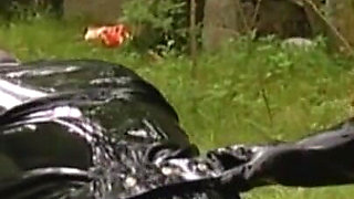 Guy in latex dress humiliated in the garden