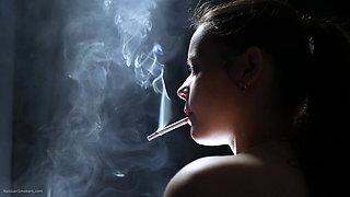 Topless Brunette Smoking in Dramatic Smoke