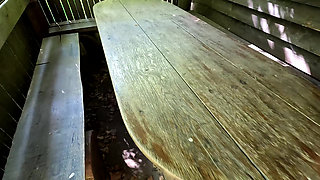 Whipping her ass and vagina on the picnic table