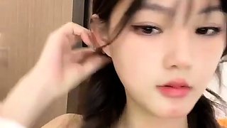 Amateur Asian babe sucks a lolly as she rubs her pussy
