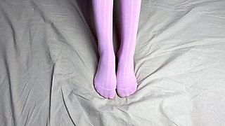 Pink socks in hands of mistress with blue nails in solo video