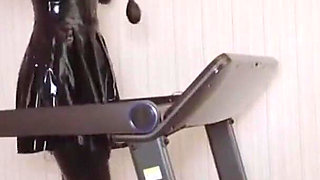 Mz24 - a Girl Bound to a Treadmill with Metal Restraints and Shackles