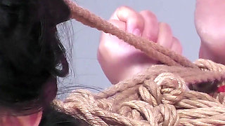 Miwa Kiritani with Her Back Arched in a Controlled Bondage Session