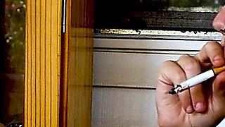 Shaved Head Goth Smokes Outside