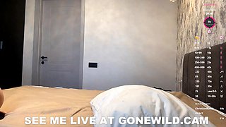 Blonde Bombshell Poses Seductively in Sheer Black Lingerie on Bed