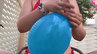 Blowing Balloons Outside in Cute Bikini