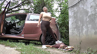 Mistress Jenna Stands on the Slave with a Car While Smoking in the Slave's Mouth