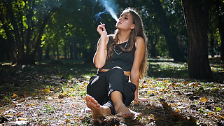 Seductive Russian Beauty Smoking Cigarette in Studio