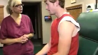 Milf Carey Riley strokes a young guys dick in the office